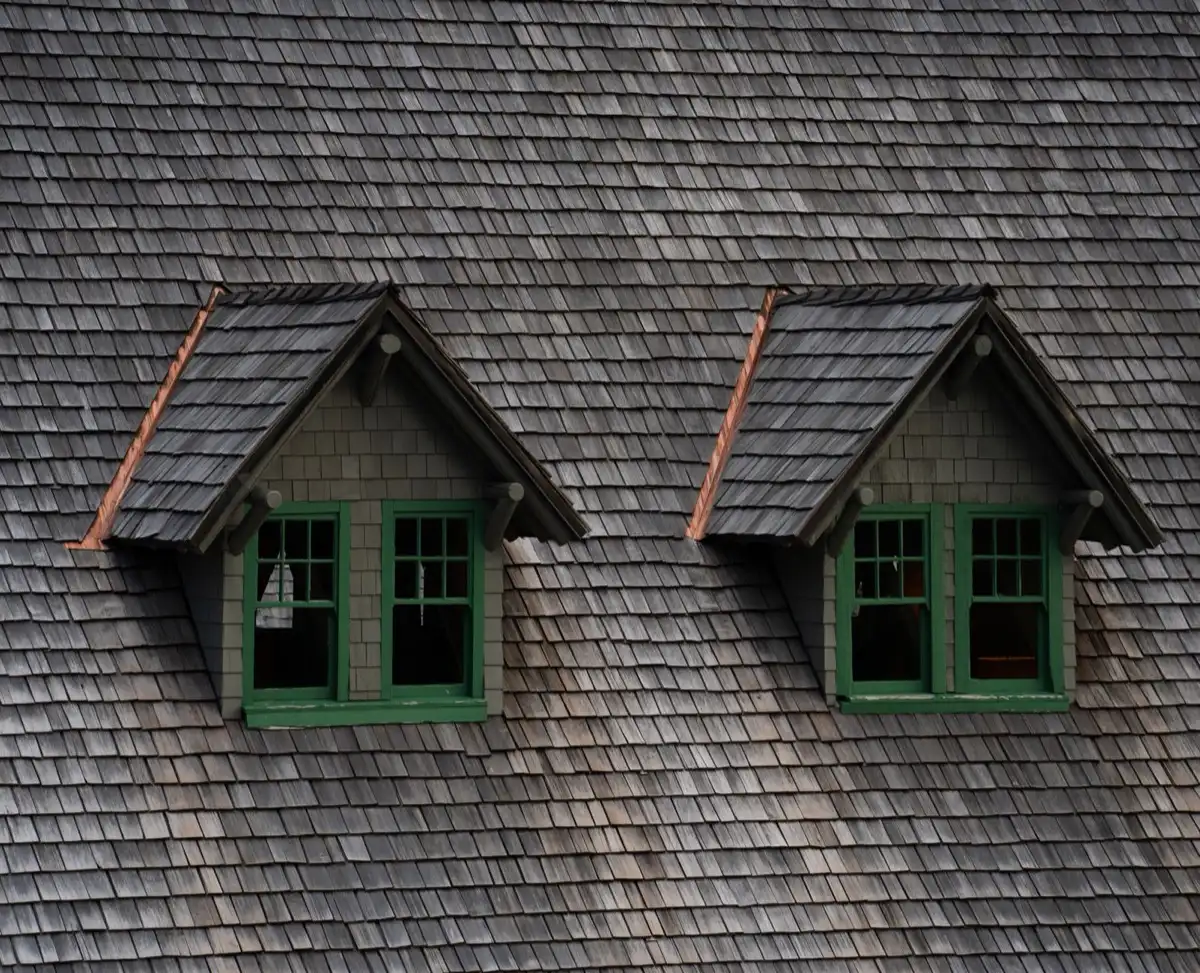 Dormers on a shingle roof in McAllen, TX, where step flashing and kickout flashing carry water past the walls